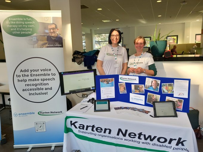 Nuvoic at TechAbility.
Two women stand, smiling, behind a table with a display about the Karten Network's Nuvoic Project. Next to them is a banner promoting Voiceitt's accessible speech recognition.
